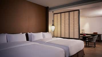 A hotel room with a large bed, a desk, and a chair.