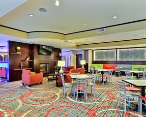 Relax in our inviting lobby with a fireplace, sofas, and dining areas.