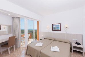 A hotel room with two beds, a desk, a chair, a balcony with a view, and a phone on the nightstand. - Hotel HSM Canarios Park - All Inclusive (Manacor)