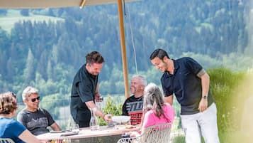 Guests can dine al fresco amidst a serene forest backdrop.
