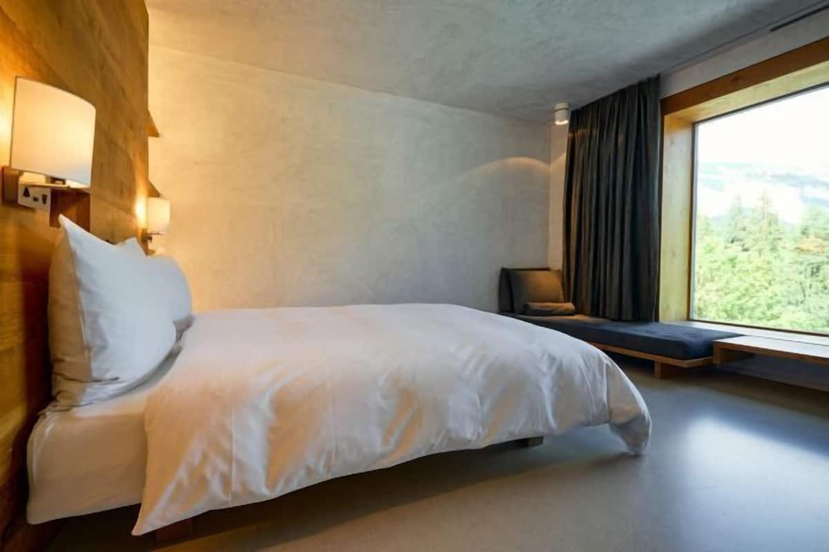 Ropa de cama hipoalergénica y caja de seguridad en la habitación