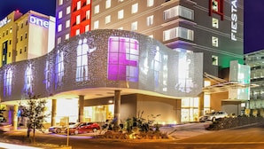A multi-story hotel with a prominent 'Fiesta Inn' sign, featuring balconies and a modern architectural design. - Fiesta Inn Queretaro Centro Sur (Querétaro)