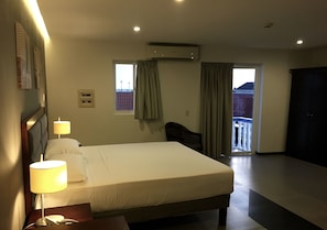 Comfort Studio Suite, Balcony, City View | In-room safe, desk, laptop workspace, iron/ironing board