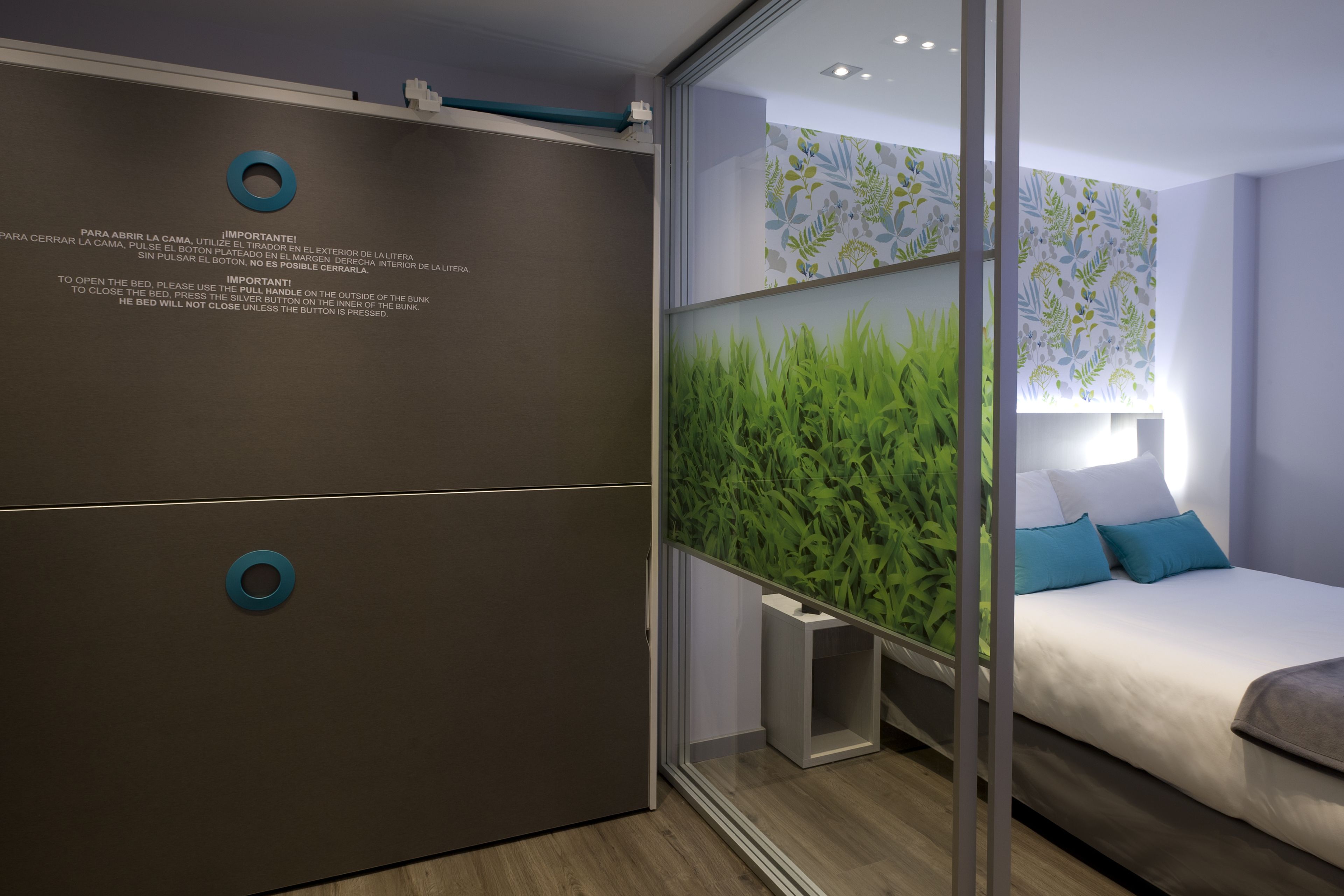 A modern bedroom with a bed, a wardrobe, and a green plant wall.