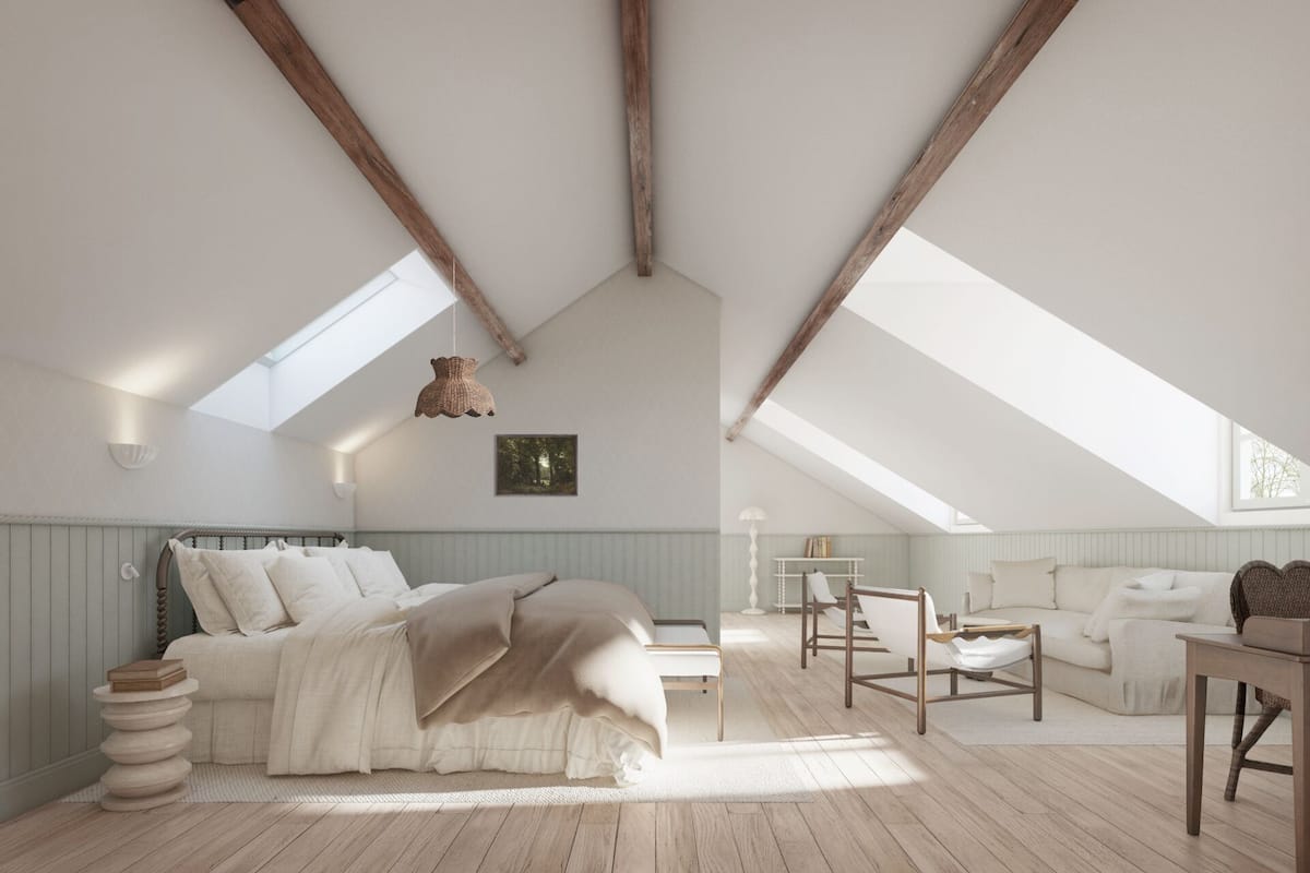 A spacious attic bedroom with a sloped ceiling, a bed, a sofa, and a dining table.