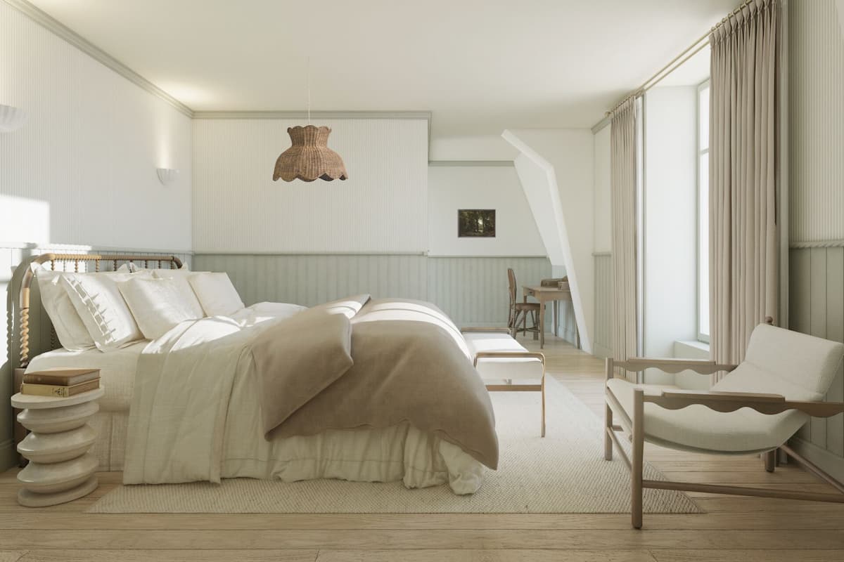 A bedroom with a bed, a chair, a desk, and a hanging light fixture.