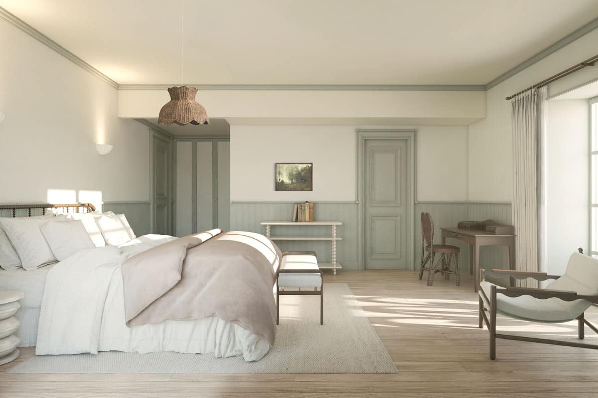 A bedroom with a bed, bedside table, chair, desk, and a hanging light fixture.