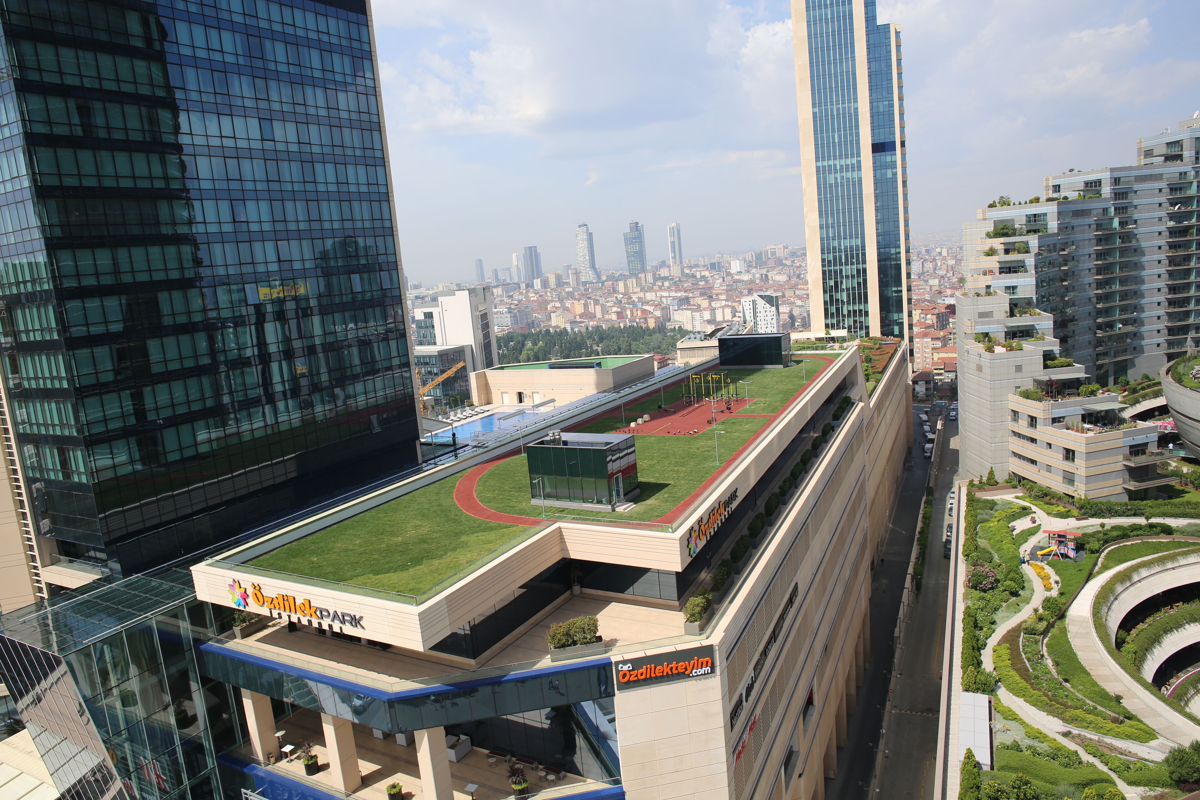 A modern building with a rooftop garden and a sign for 'GazpromPark'.