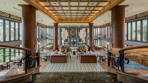 A spacious lobby with a central seating area, large windows, and a high ceiling with wooden beams. - Palm Garden Hotel, Putrajaya, a Tribute Portfolio Hotel (Serdang)