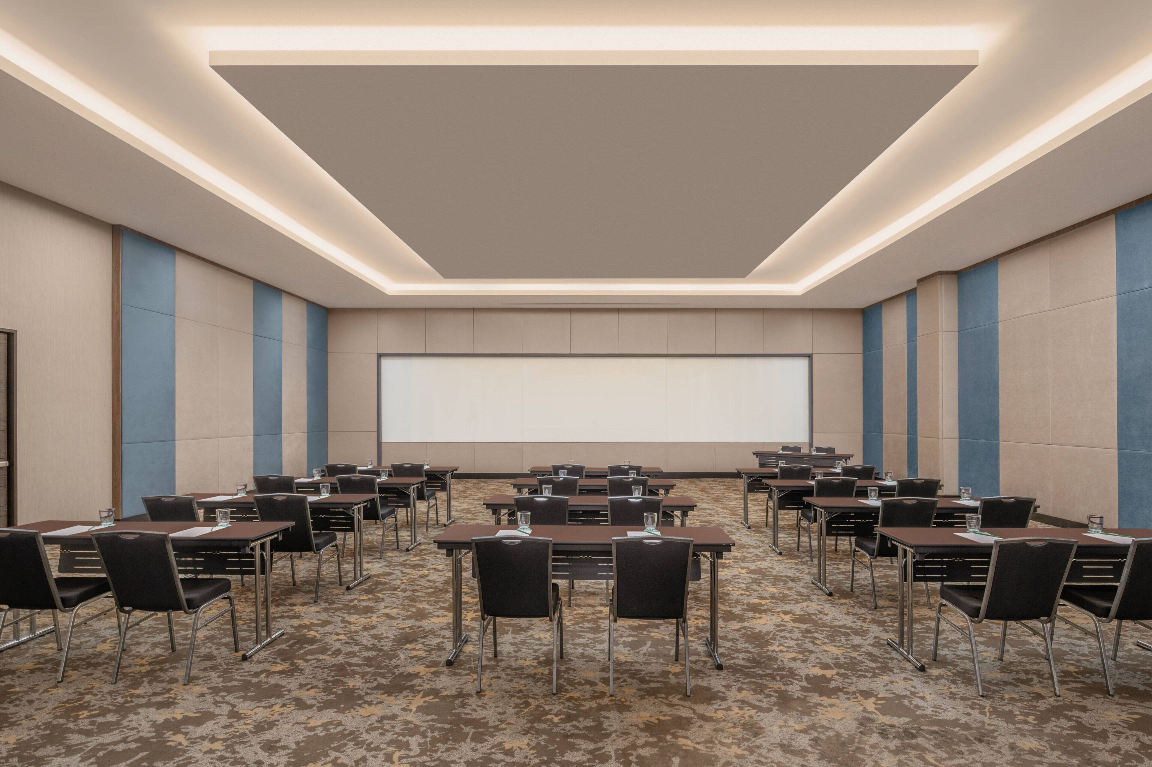 A conference room with tables and chairs arranged for a meeting.