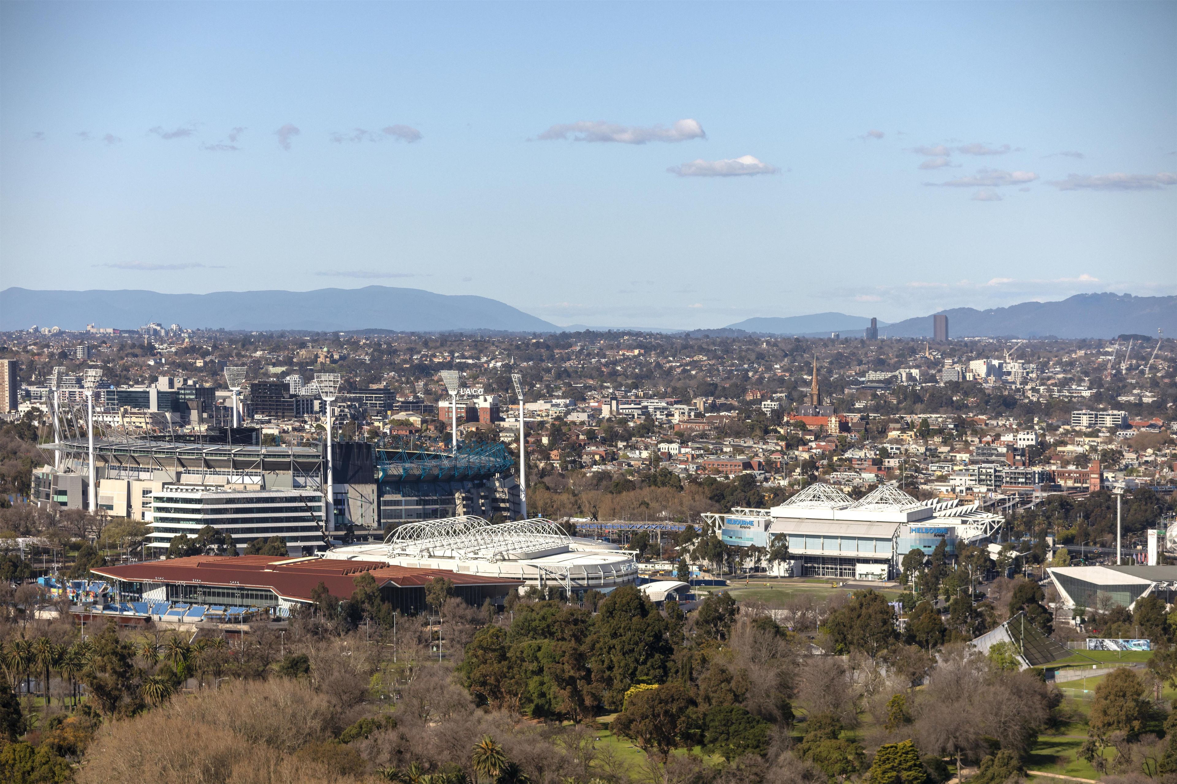 A cityscape with a stadium, office buildings, and residential areas.
