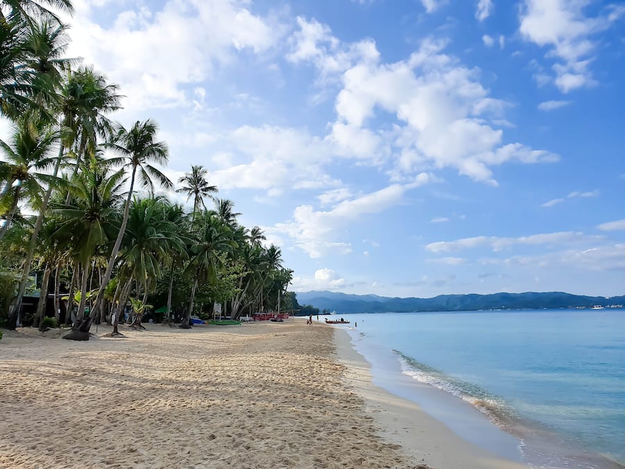 On the beach, white sand, beach towels, beach massages