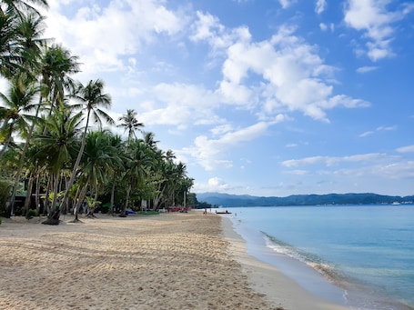 On the beach, white sand, beach towels, beach massages