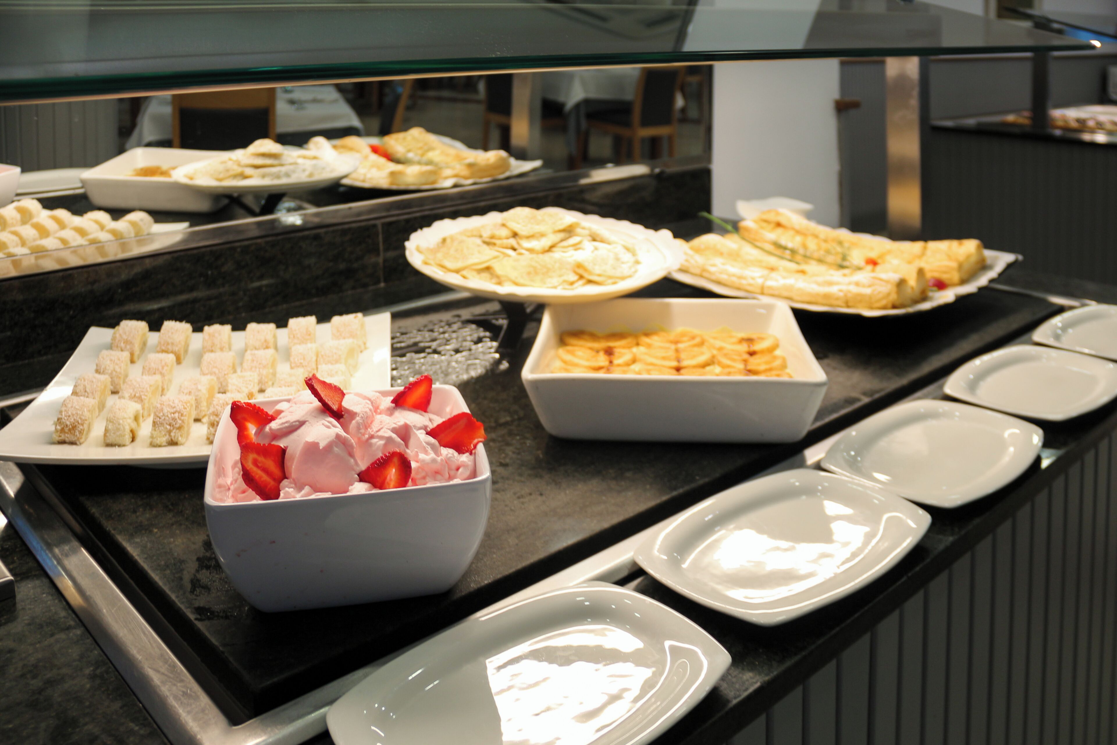 A buffet with various desserts and pastries.