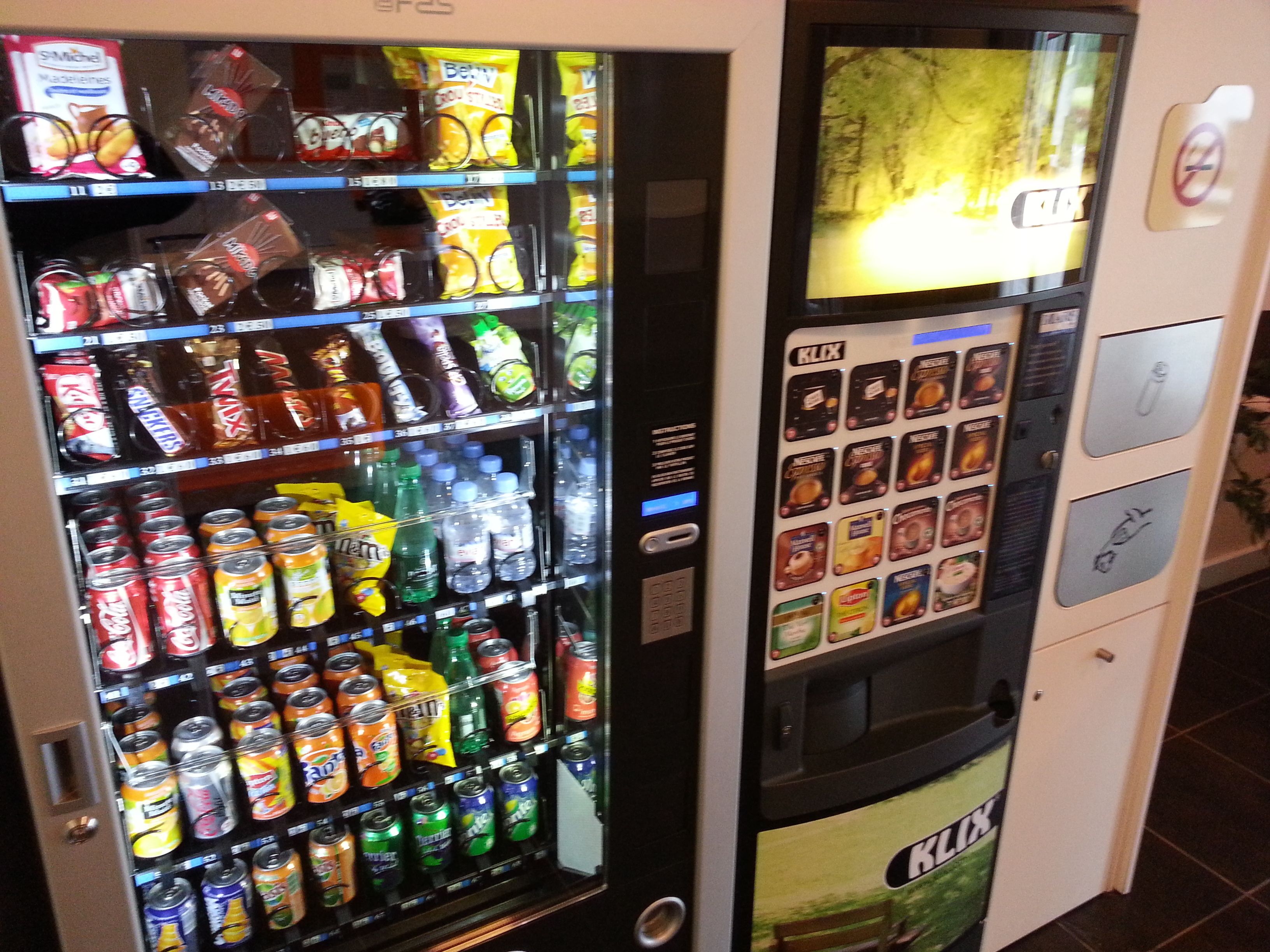 A vending machine with various snacks, drinks, and ice cream options.
