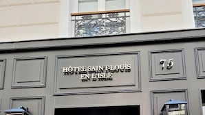 The facade of Hotel Saint-Louis En l'Isle, featuring a classic black exterior with a prominent entrance and numbered address 75. - Hotel Saint-Louis en L'Isle - Notre-Dame (Paris)
