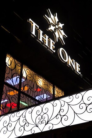 A building with a sign that reads "THE ONE" and a star above the text. - The One Boutique Hotel (Flushing)