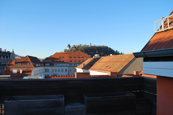 Blick auf eine Stadt mit Gebäuden und einem Hügel im Hintergrund.