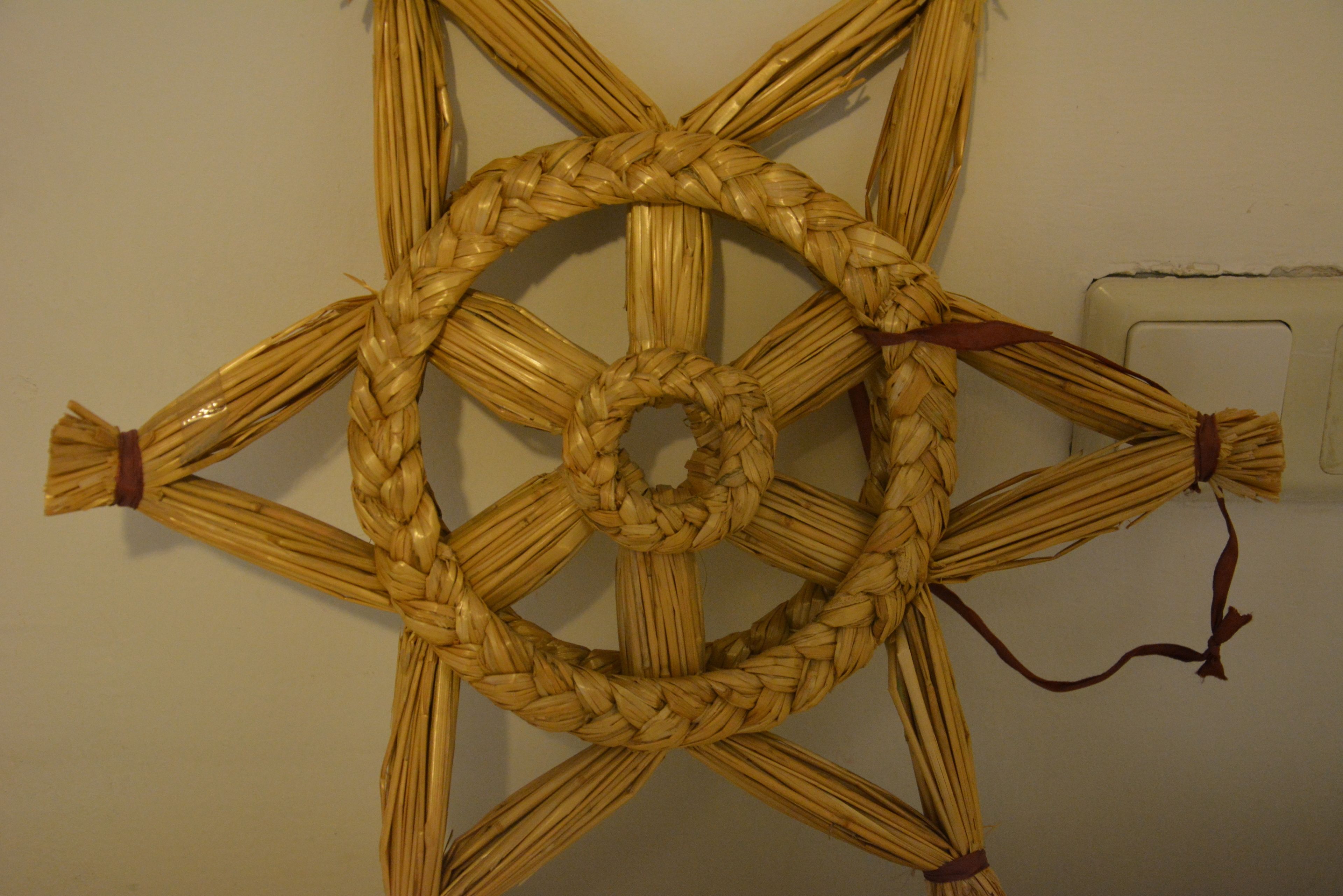 Un pannello decorativo tessuto con un centro circolare e raggi che si irradiano.