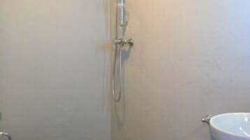 A small bathroom with a shower, toilet, and sink.