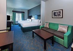 A hotel room with a bed, a sofa, a desk, and a television. - Holiday Inn Express & Suites Killeen - Fort Hood Area by IHG (Killeen)