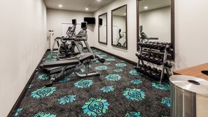 A gym with exercise equipment, a mirror, and a wall-mounted TV. - Holiday Inn Express & Suites Killeen - Fort Hood Area by IHG (Killeen)