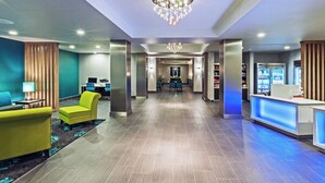 A hotel lobby with a reception desk, seating area, and a chandelier. - Holiday Inn Express & Suites Killeen - Fort Hood Area by IHG (Killeen)