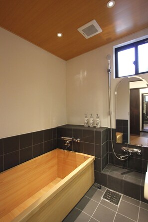 Separate bathtub and shower, deep-soaking bathtub, designer toiletries