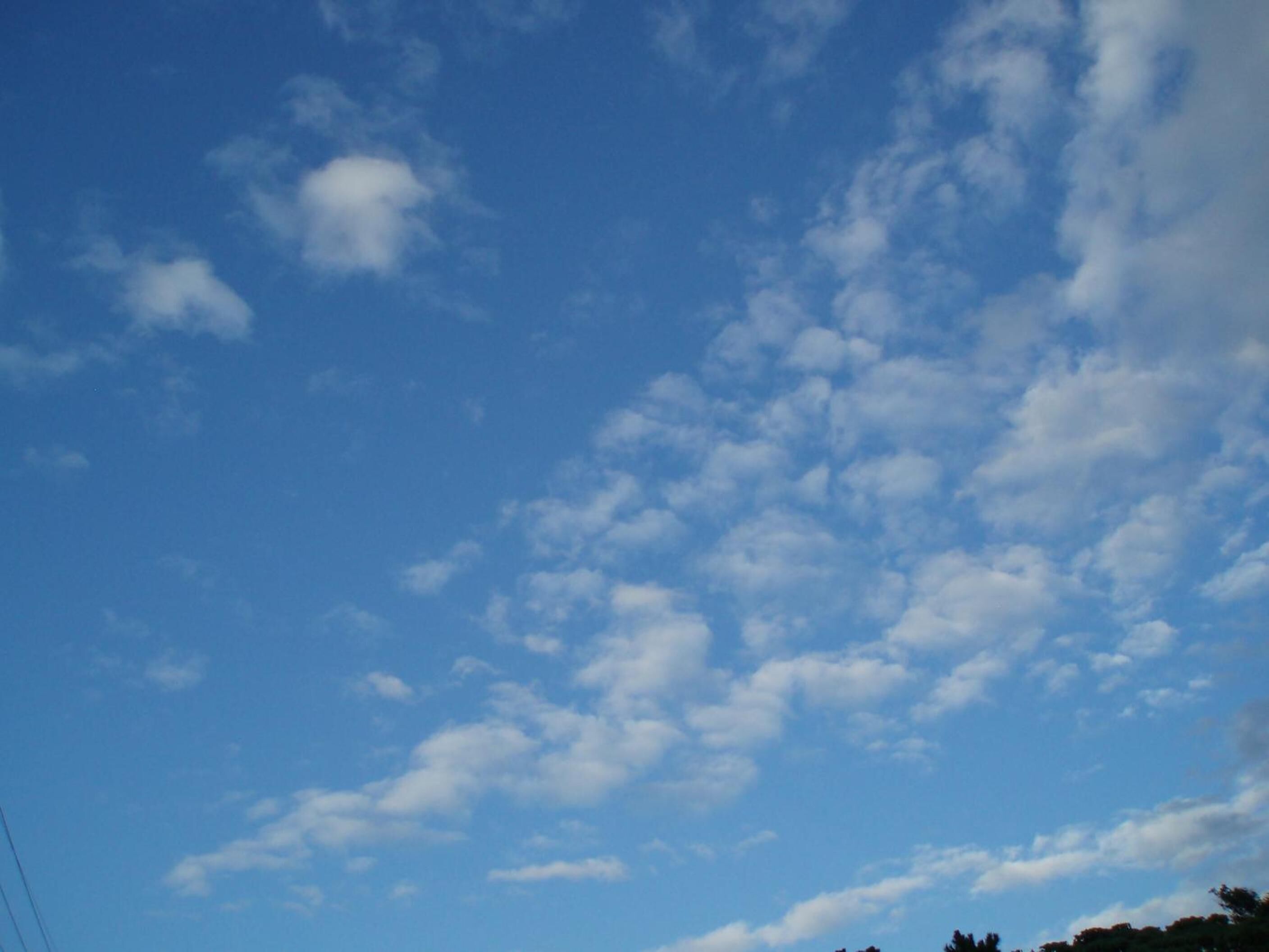 A clear blue sky with scattered clouds.