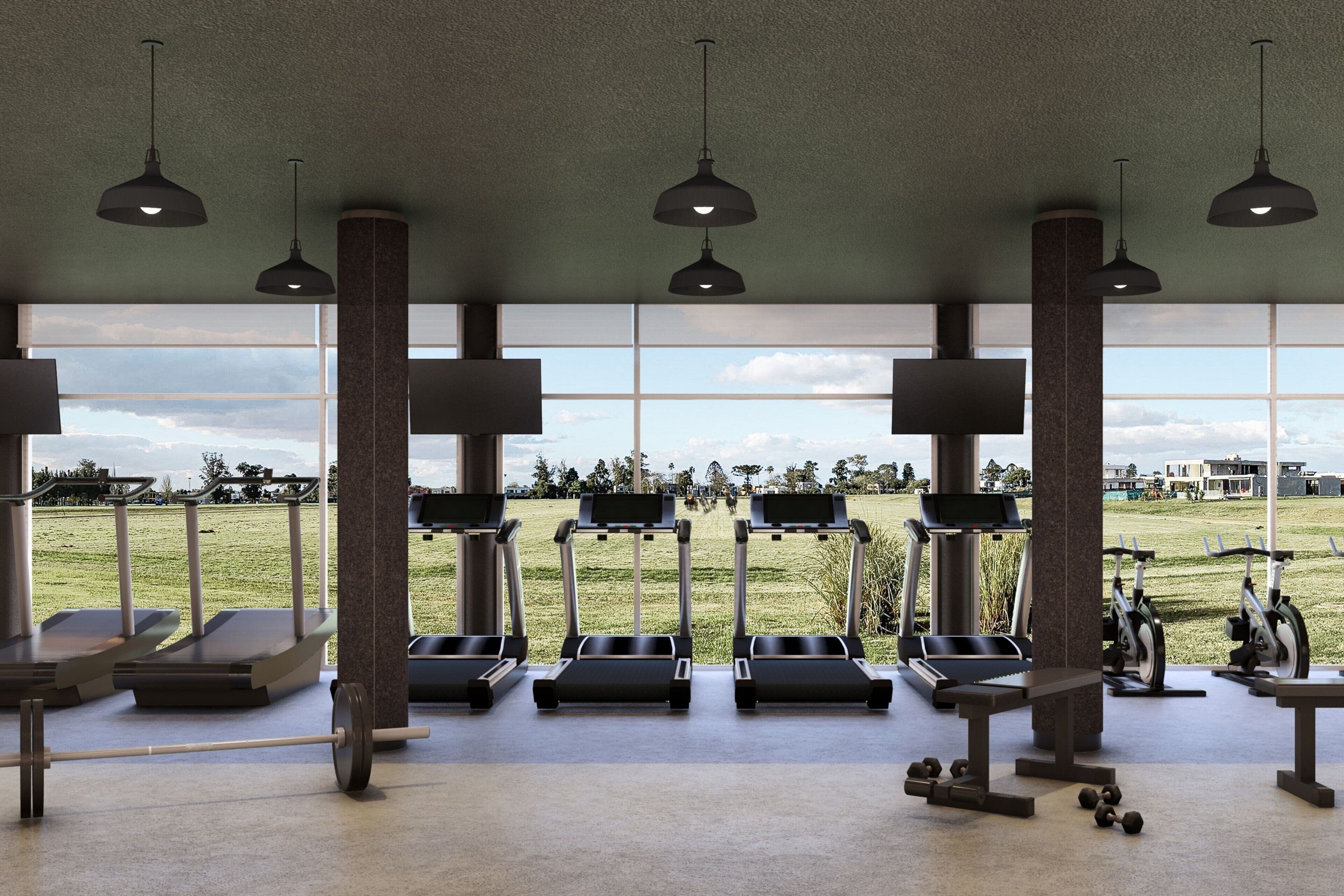 Une salle de sport équipée de tapis de course, de vélos elliptiques et de poids libres, avec de grandes fenêtres donnant sur un parc.
