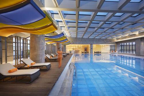 Indoor pool, open 6:00 AM to 11:00 PM, pool umbrellas