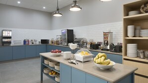 A buffet area with a variety of food items, including fruits and a buffet station. - Country Inn & Suites by Radisson, Katy (Houston West), TX (Katy)