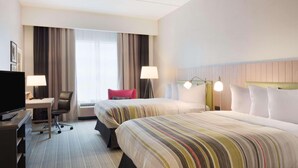 A hotel room with two beds, a desk, a TV, and a window with curtains. - Country Inn & Suites by Radisson, Katy (Houston West), TX (Katy)