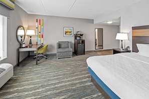 A hotel room with a bed, desk, chair, and a microwave. - Hampton Inn & Suites Camp Springs/Andrews AFB (Suitland)