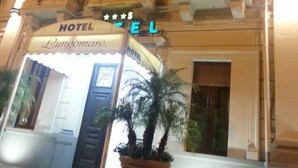 A hotel facade with a classic architectural style, featuring arched windows and balconies. The hotel's name is displayed prominently above the entrance. - Lungomare Hotel (Reggio Calabria)