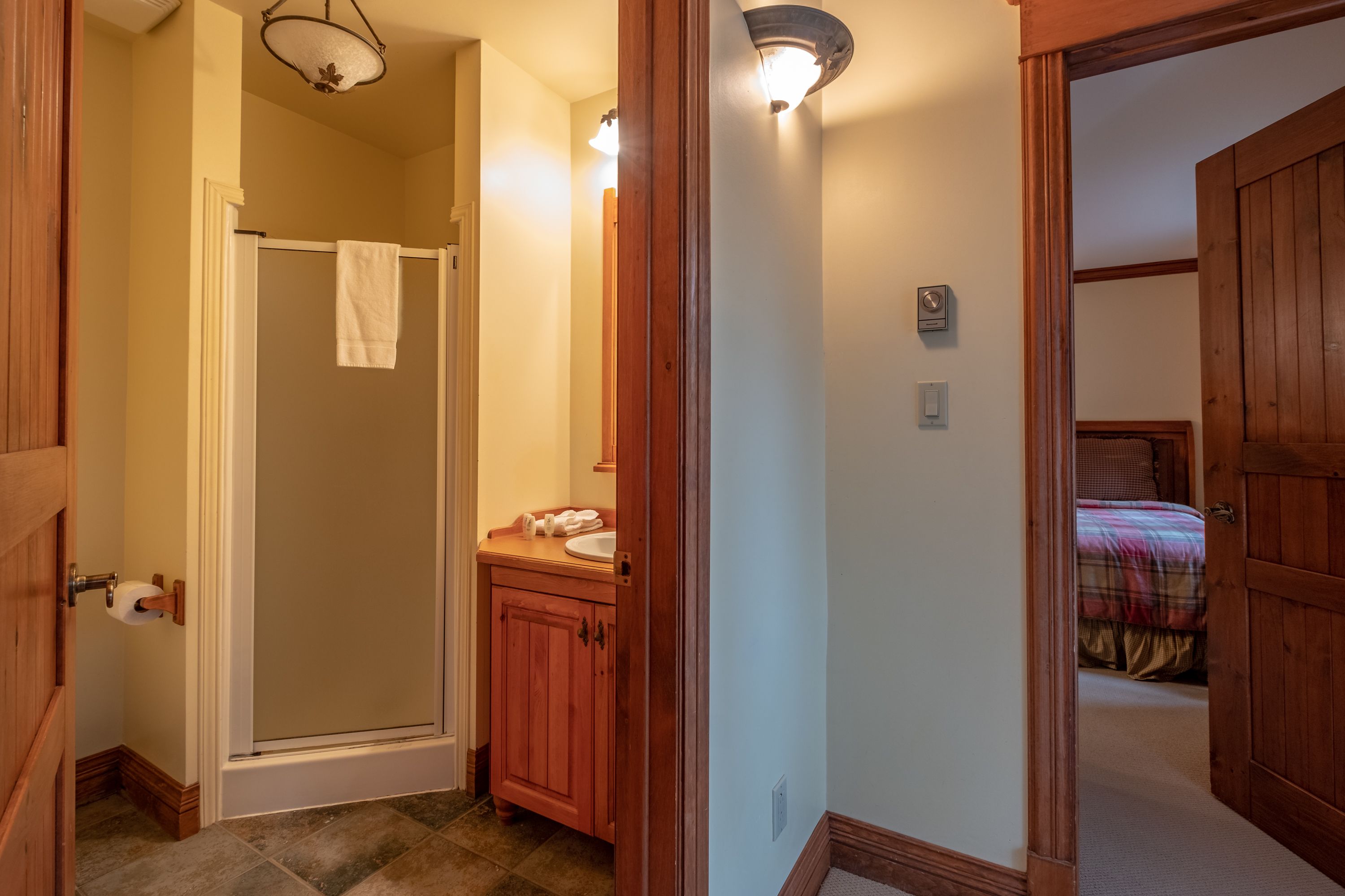 A bathroom with a shower, a sink, and a toilet.