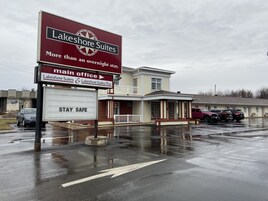 A Lakeshore Suites main office building with a sign indicating the direction to the main office.