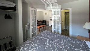 Quarto com cama, escrivaninha, cadeira e guarda-roupa.