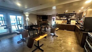 A spacious indoor area with a bar and seating. - Big Lake Inn (Slave Lake)