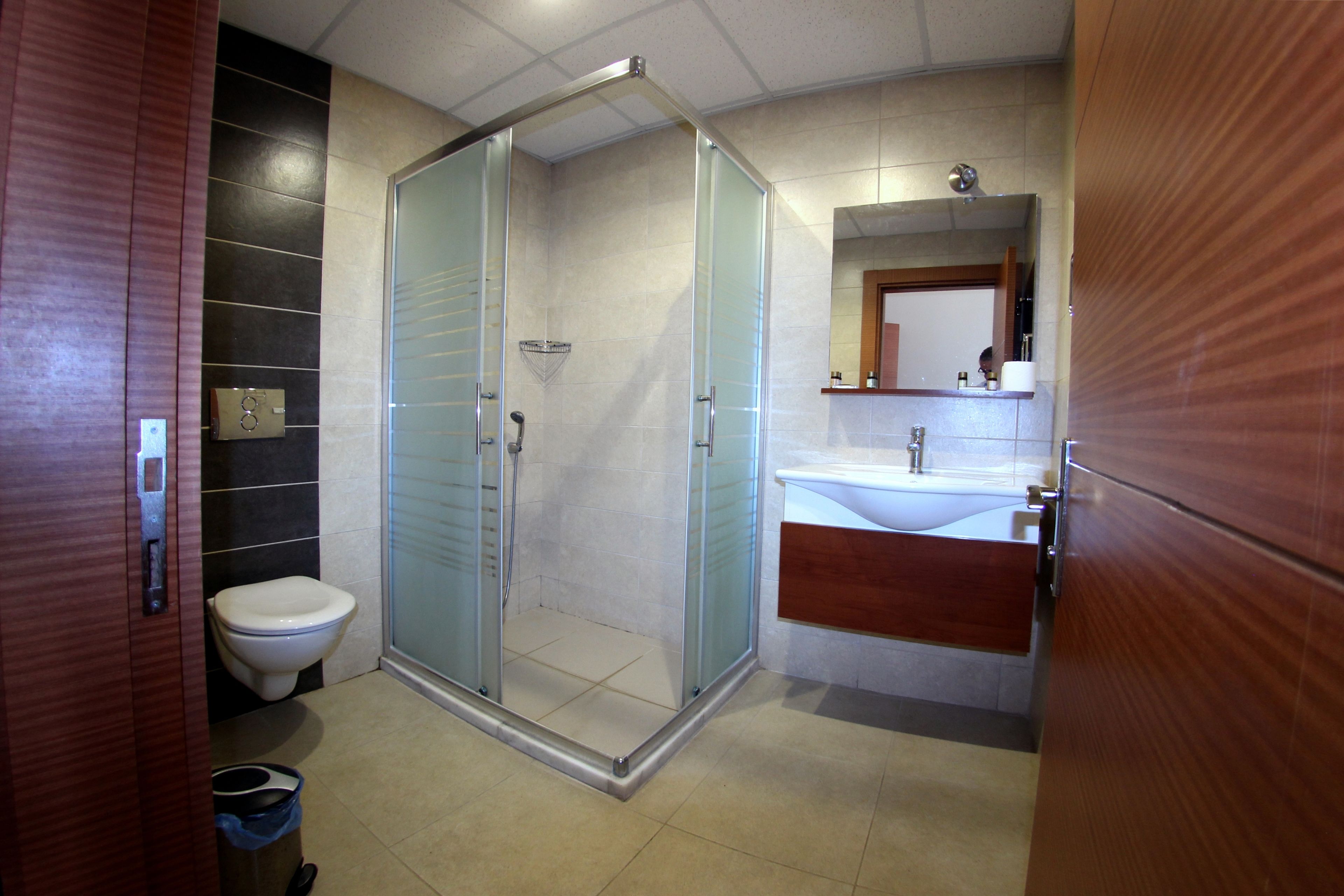 shower, hair dryer, slippers, towels