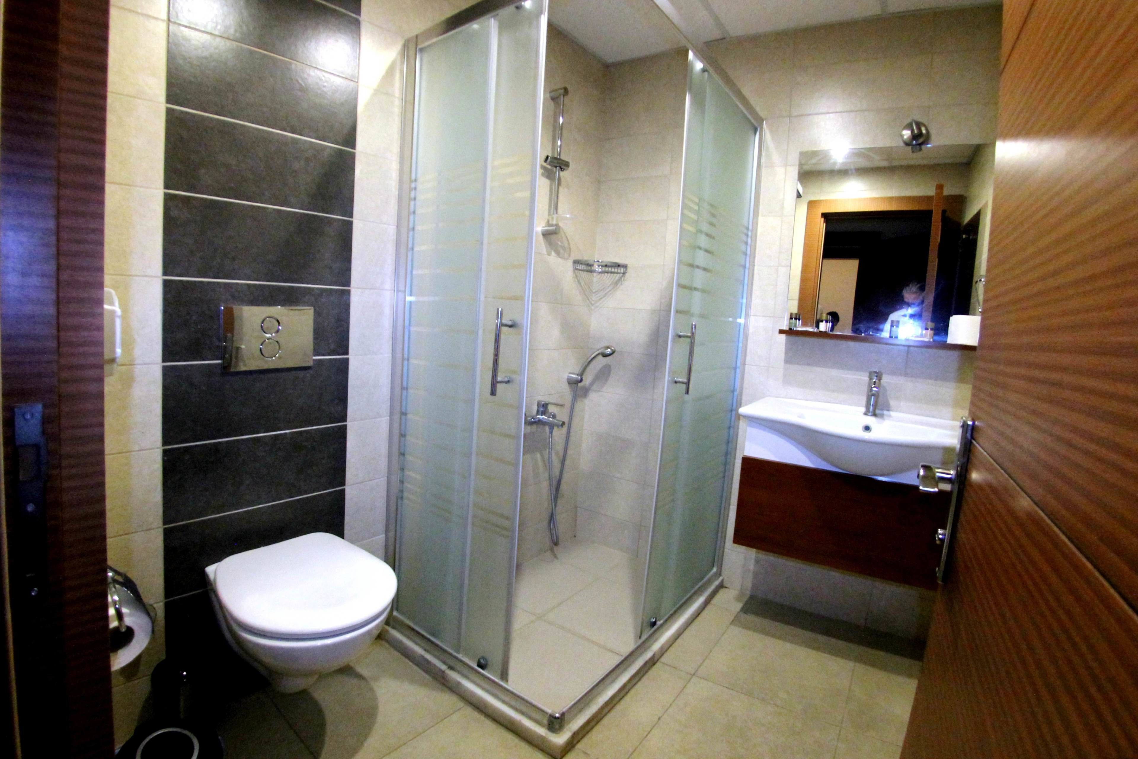 shower, hair dryer, slippers, towels