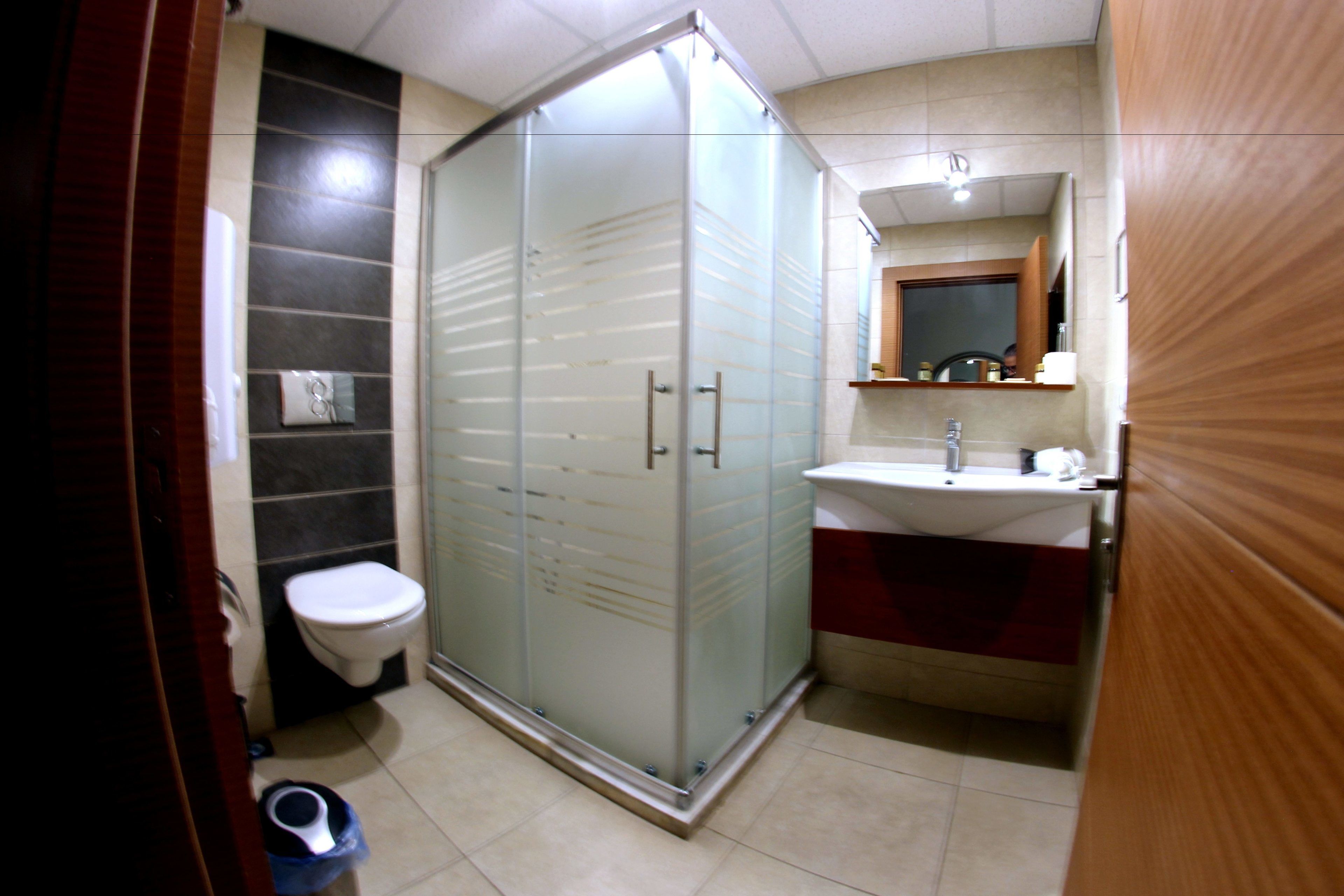 shower, hair dryer, slippers, towels