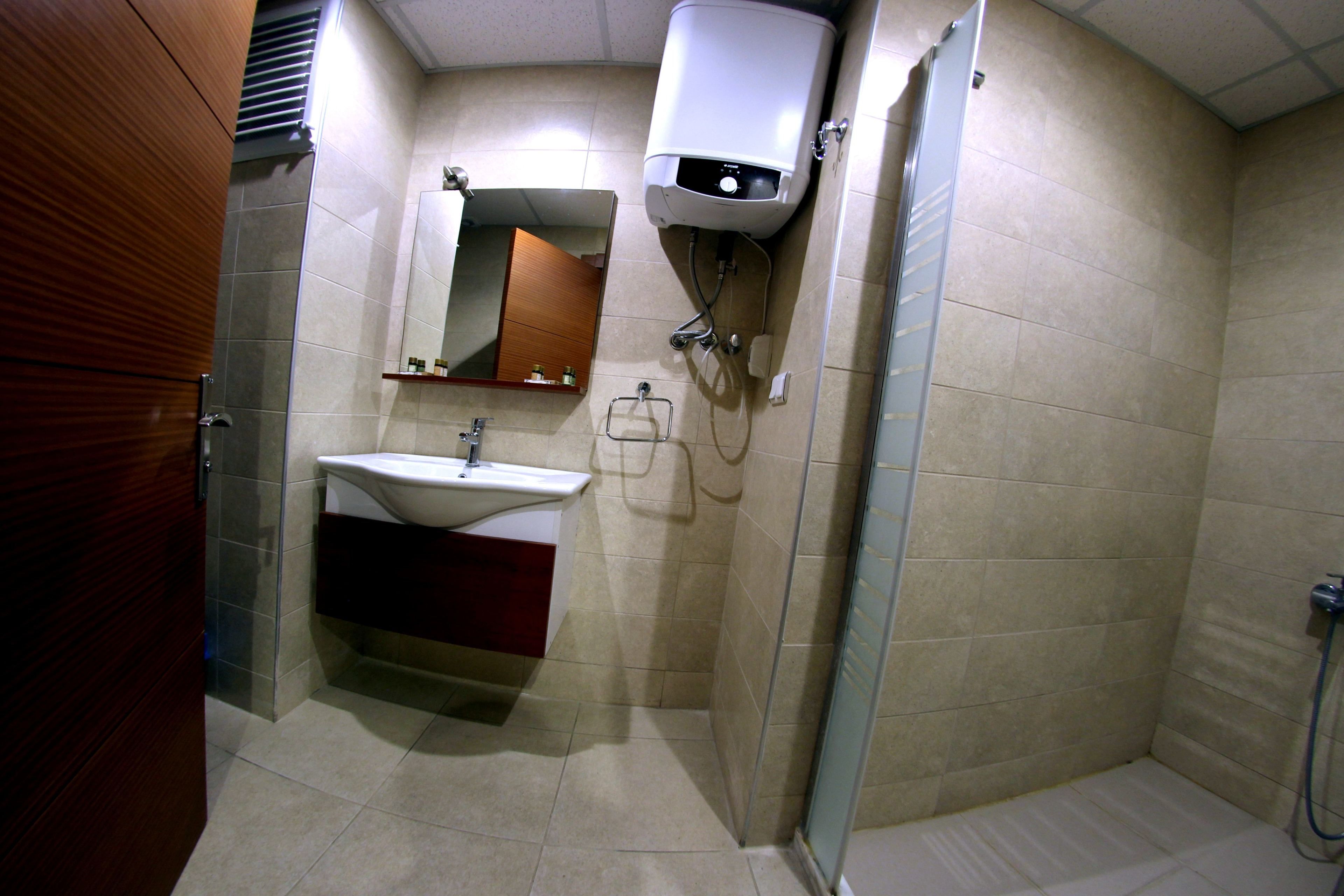 deluxe double room | bathroom | shower, hair dryer, slippers, towels