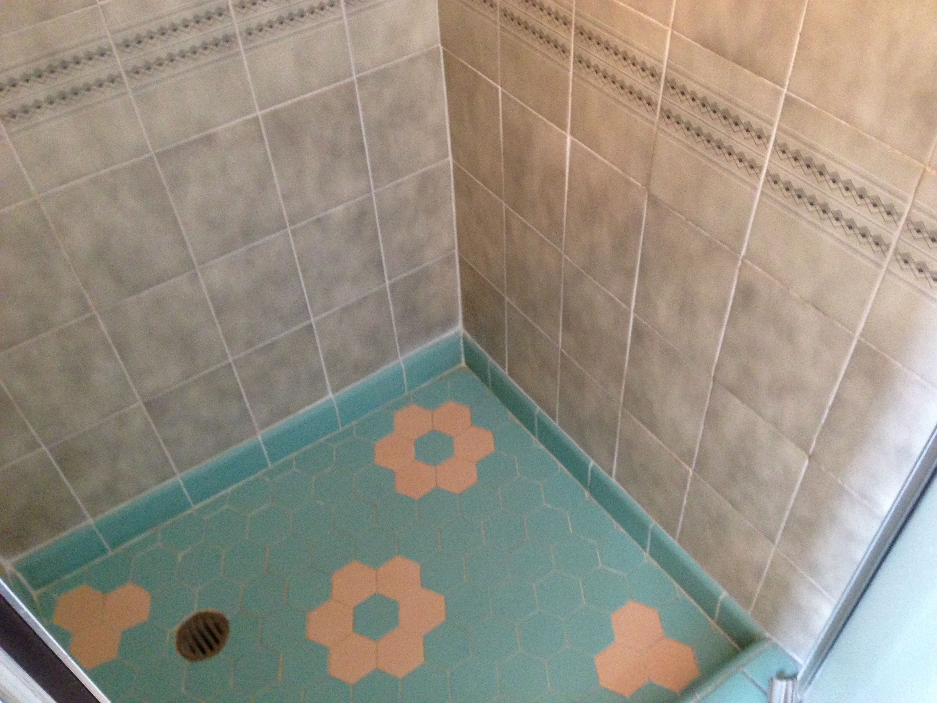 A bathroom with a blue floor and beige tiles.