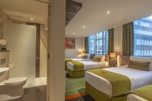 Classic Quadruple Room | Minibar, in-room safe, desk, blackout drapes