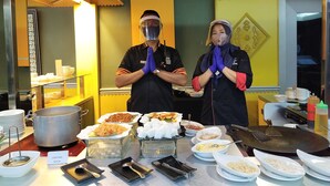 A buffet setup with various dishes and a sign reading "Gerai Melayu" in the background. - Furaya Hotel (Pekanbaru)