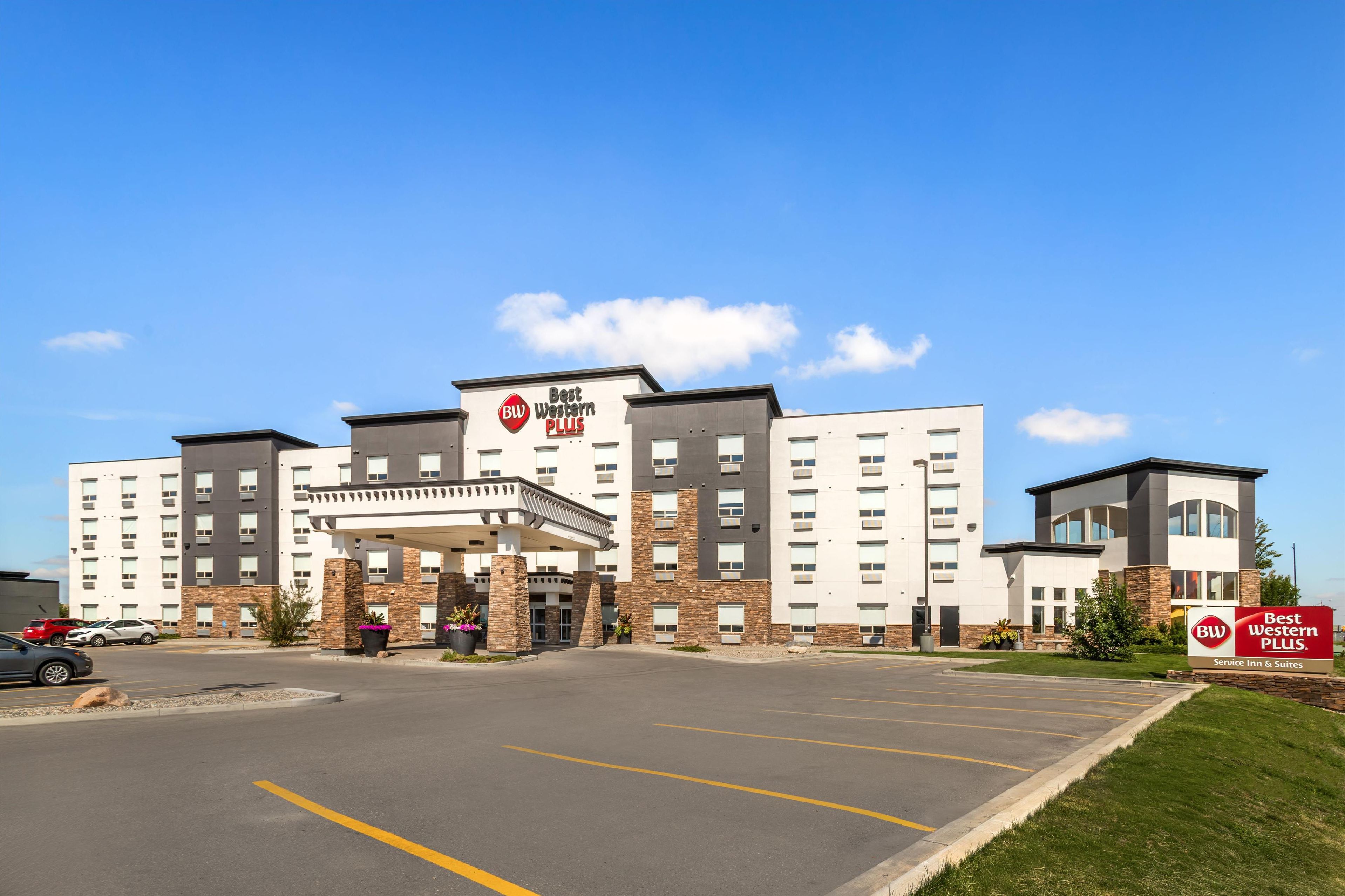 A Best Western Plus hotel with a central entrance, multiple floors, and a parking lot.
