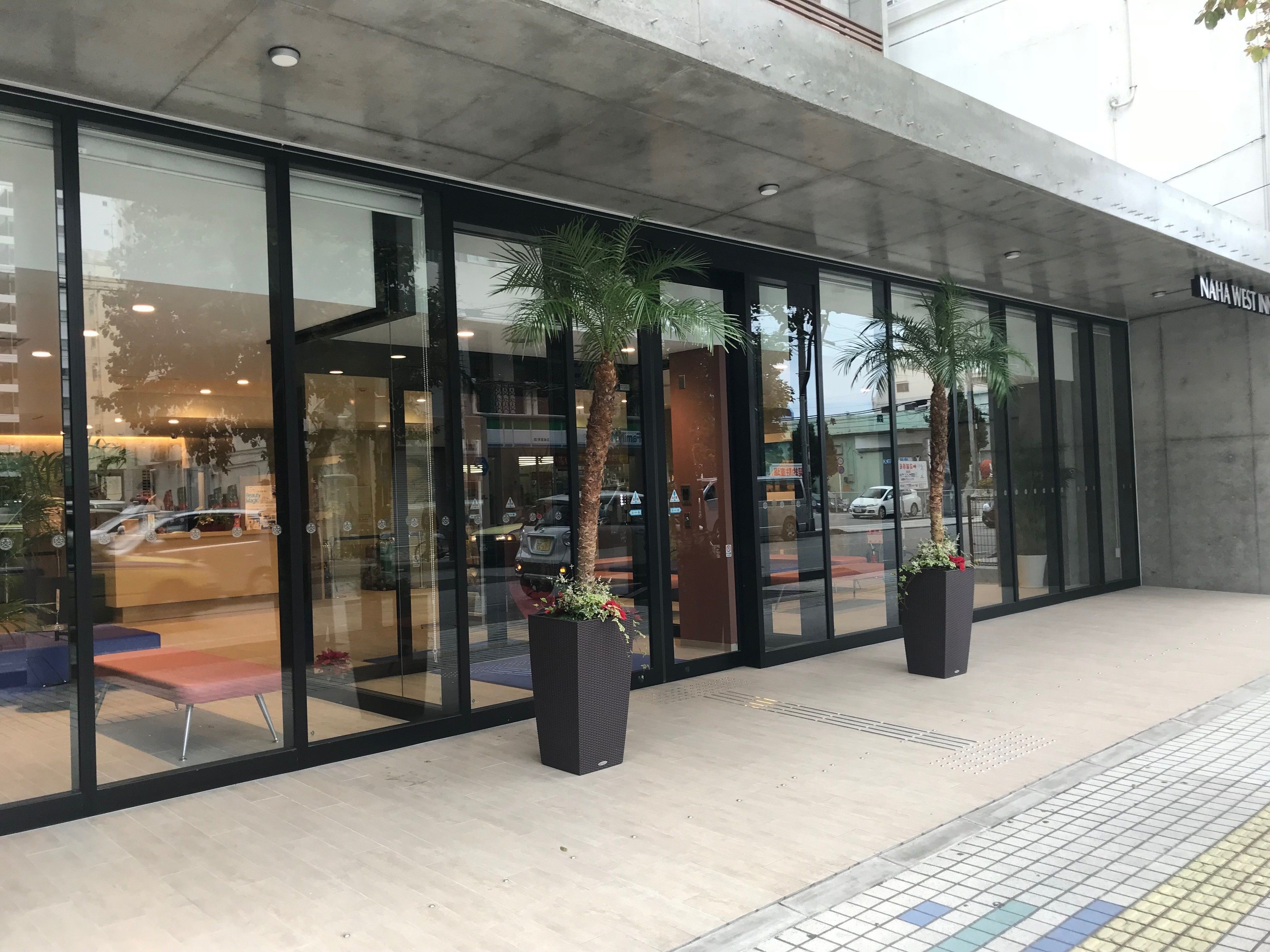 A modern building with large glass windows and a concrete facade.