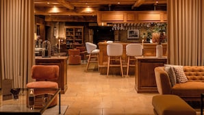 A cozy, well-lit interior with wooden beams, a bar area, and comfortable seating. - Les Manoirs de Tourgéville (Tourgeville)