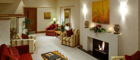 A spacious living area with a fireplace, sofas, and a coffee table.